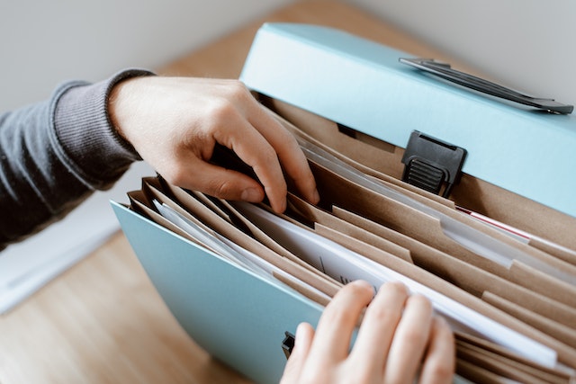 person going through a portable filing portfolio